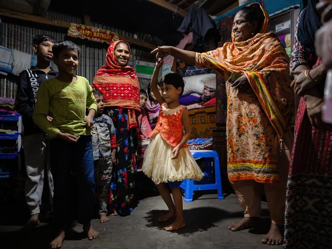 Annat, aged 5, twirls around in her tutu at the home of friends in Dhaka's slums, Bangladesh. Olympian Emma McKeon, a UNICEF Australia ambassador, visits one of the slum areas in Bangladesh at Korial, in the capital Dhaka. Picture: Jason Edwards