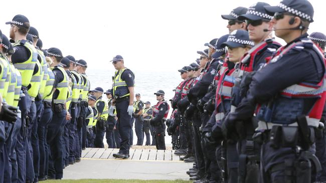 Police line up to keep the peace at St Kilda beach on Saturday. Picture: Matrix