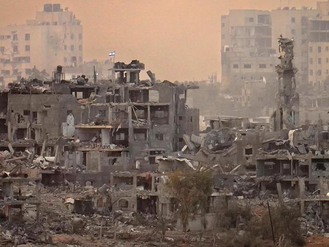 An Israeli flag flys on top of destroyed building next to a mosque in northern Gaza. Picture: AFP