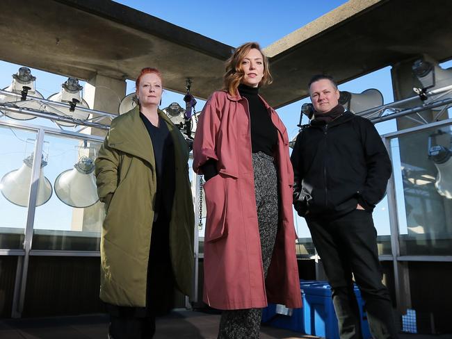 Singer Carolyn Connors, left, with <i>Siren Song </i>artists Hannah Fox and Bryon J Scullin on the roof of 10 Murray St with one of the six banks of speakers around the Hobart waterfront. Picture: RICHARD JUPE