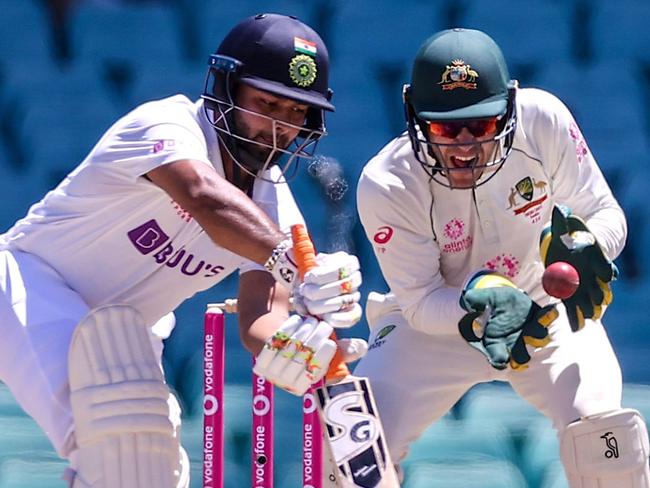 Australia's wicketkeeper Tim Paine drops a catch from India's Rishabh Pant (L) during day five of the third cricket Test match between Australia and India at the Sydney Cricket Ground (SCG) on January 11, 2021. (Photo by DAVID GRAY / AFP) / -- IMAGE RESTRICTED TO EDITORIAL USE - STRICTLY NO COMMERCIAL USE --