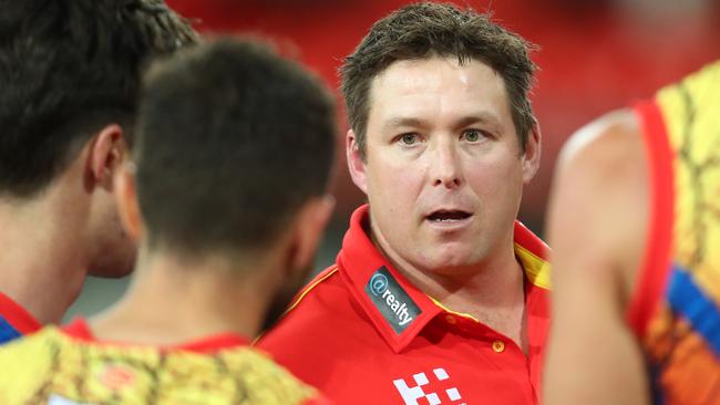 Suns coach Stuart Dew talks with players during the loss to Adelaide.