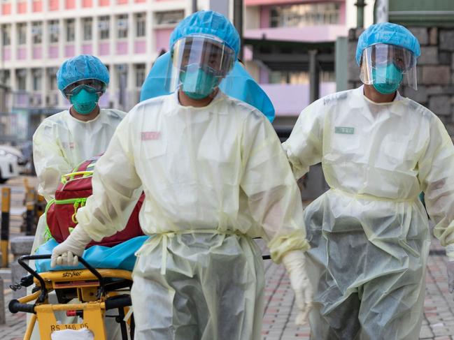 (FILES) This file photo taken on August 23, 2020 shows medical staff wearing personal protective equipment (PPE) as a precautionary measure against the COVID-19 coronavirus approaching a care home in Hong Kong. - The majority of deaths in the city's latest Covid-19 wave are the elderly, Hong Kong's most vaccine-hesitant population, and more than half are tenants in overcrowded care homes across the city. (Photo by May JAMES / AFP) / TO GO WITH Health-virus-HongKong-China-elderly,FOCUS by Su Xinqi