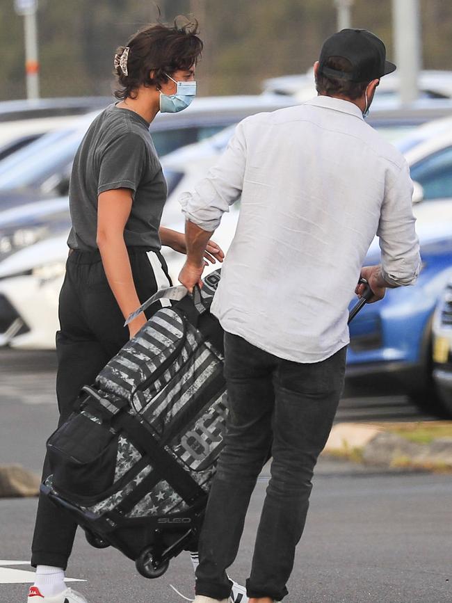 Ever the gentleman! Efron helps his girl with her bag. Picture: Media Mode