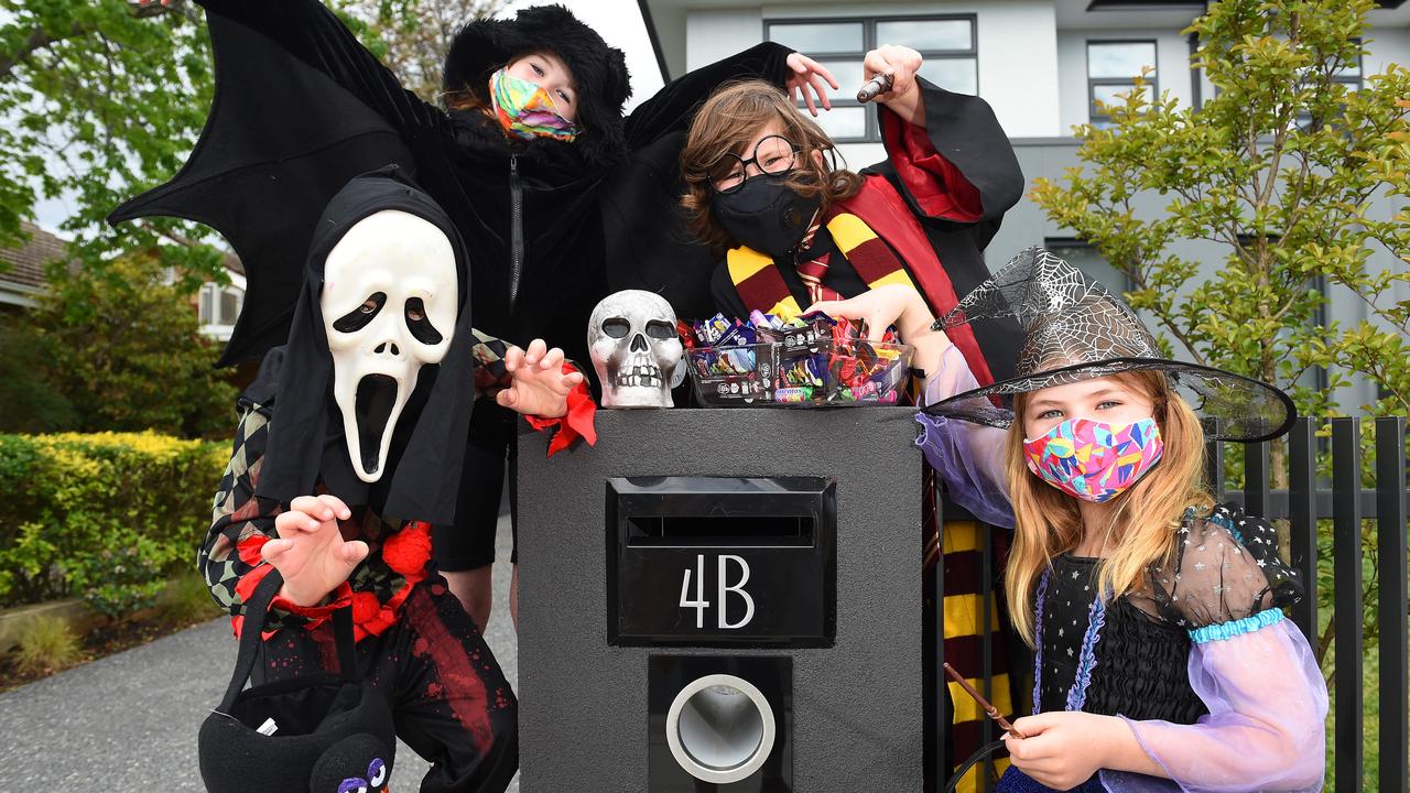 Halloween is the perfect holiday for rocking your best face mask. From left, Sebastian Lamb, 6, Sophie Ashford, 9, Jackson Lamb, 8, and Lucy Ashford, 6, are also opting for Covid-safe pre-wrapped treats. Picture: Josie Hayden