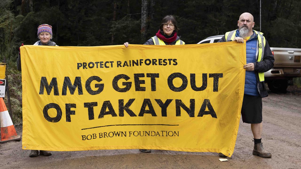 Protesters from the Bob Brown Foundation share their message at the entrance of the access road to the site of the proposed MMG tailings dam near Rosebery. Picture: Grant Wells