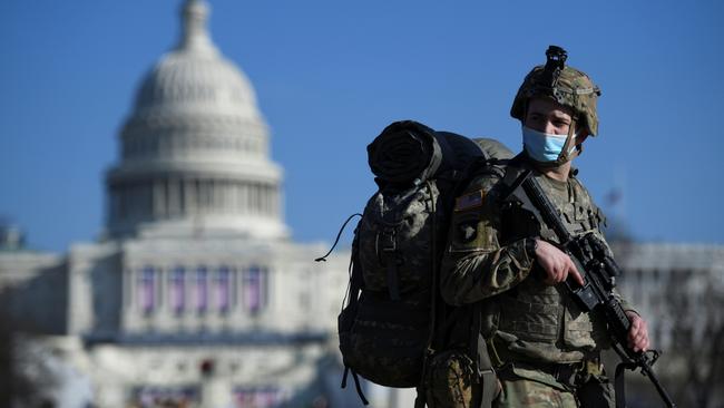 A member of the National Guard mounts guard near the U.S. Capitol building, as the House of Representatives debates impeaching U.S. President Donald Trump a week after his supporters stormed the Capitol building in Washington, U.S., January 13, 2021. REUTERS/Brandon Bell