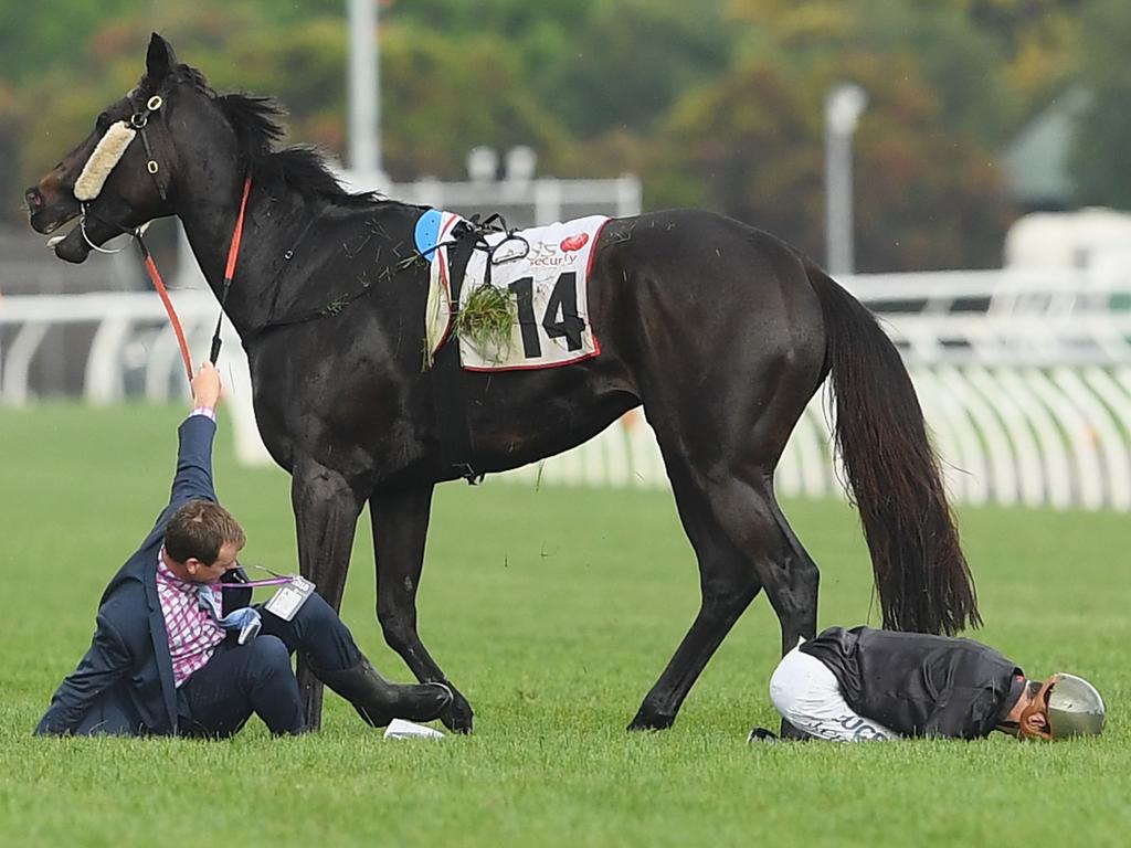 Jordan Childs sits face-first on the track after falling off Galaxy Raider. (Photo by Quinn Rooney/Getty Images)