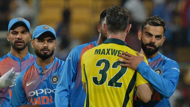 More than a game: Indian captain Virat Kohli (R) greets Australian batsman Glenn Maxwell. Picture: AFP