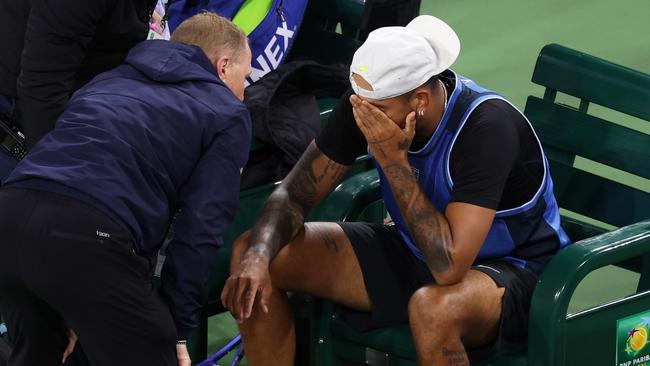 INDIAN WELLS, CALIFORNIA - MARCH 06: Nick Kyrgios of Australia shows his dejection as he is surrounded by medical personel after having to retire due to a wrist injury against Botic Van De Zandschulp of the Netherlands in their first round match during the BNP Paribas Open at Indian Wells Tennis Garden on March 06, 2025 in Indian Wells, California. (Photo by Clive Brunskill/Getty Images)