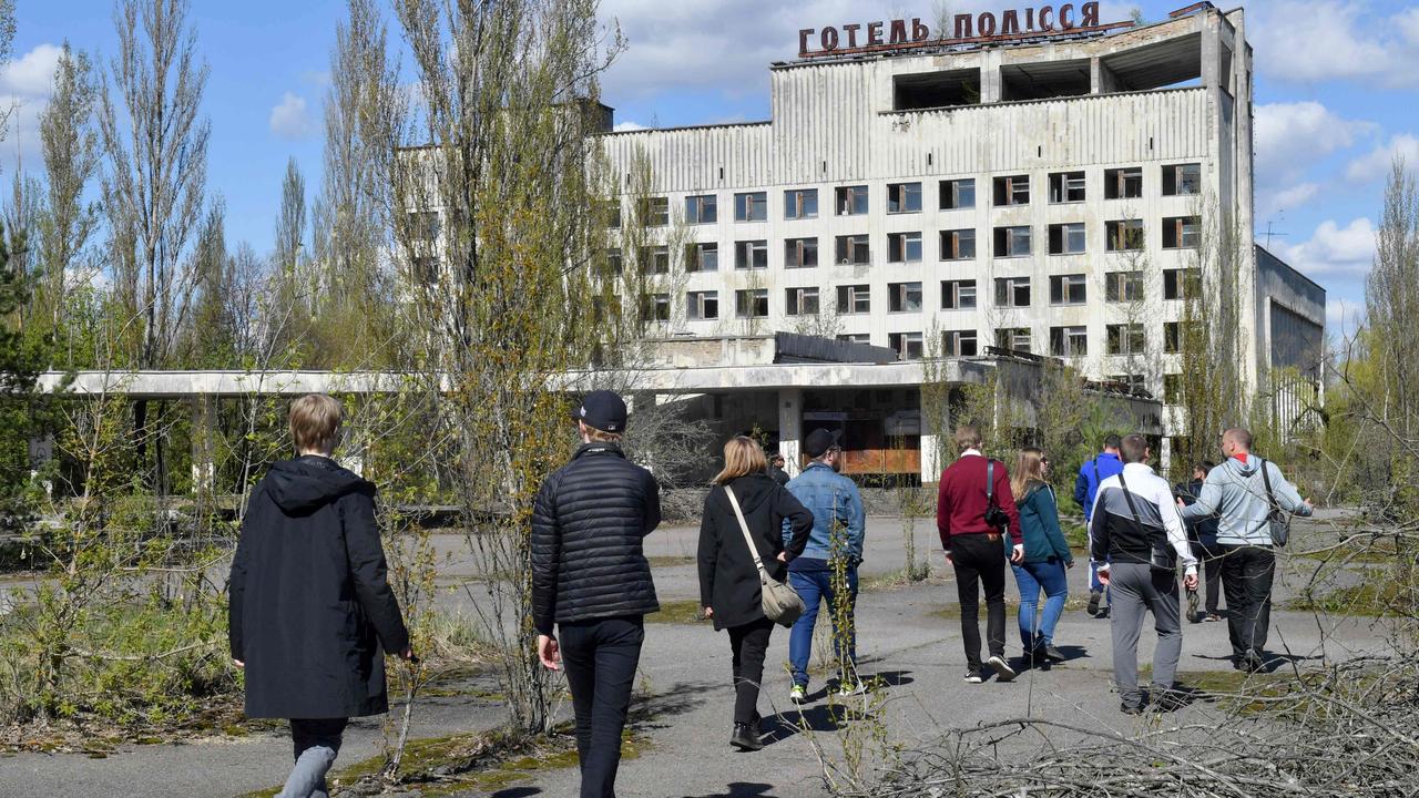 Tourists walk in the ghost city of Pripyat. Picture: Sergei Supinsky/AFP