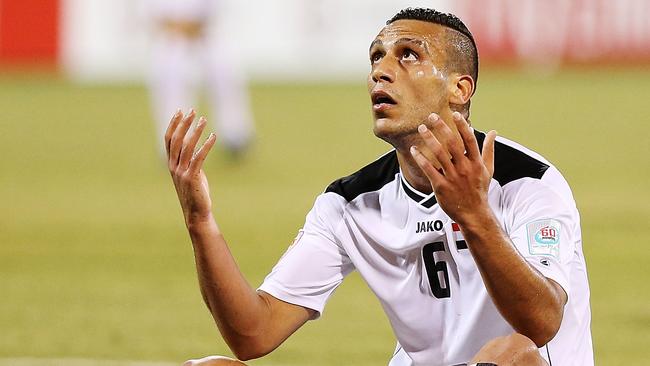 Ali Adnan Kadhim of Iraq reacts after missing a shot on goal against Palestine.