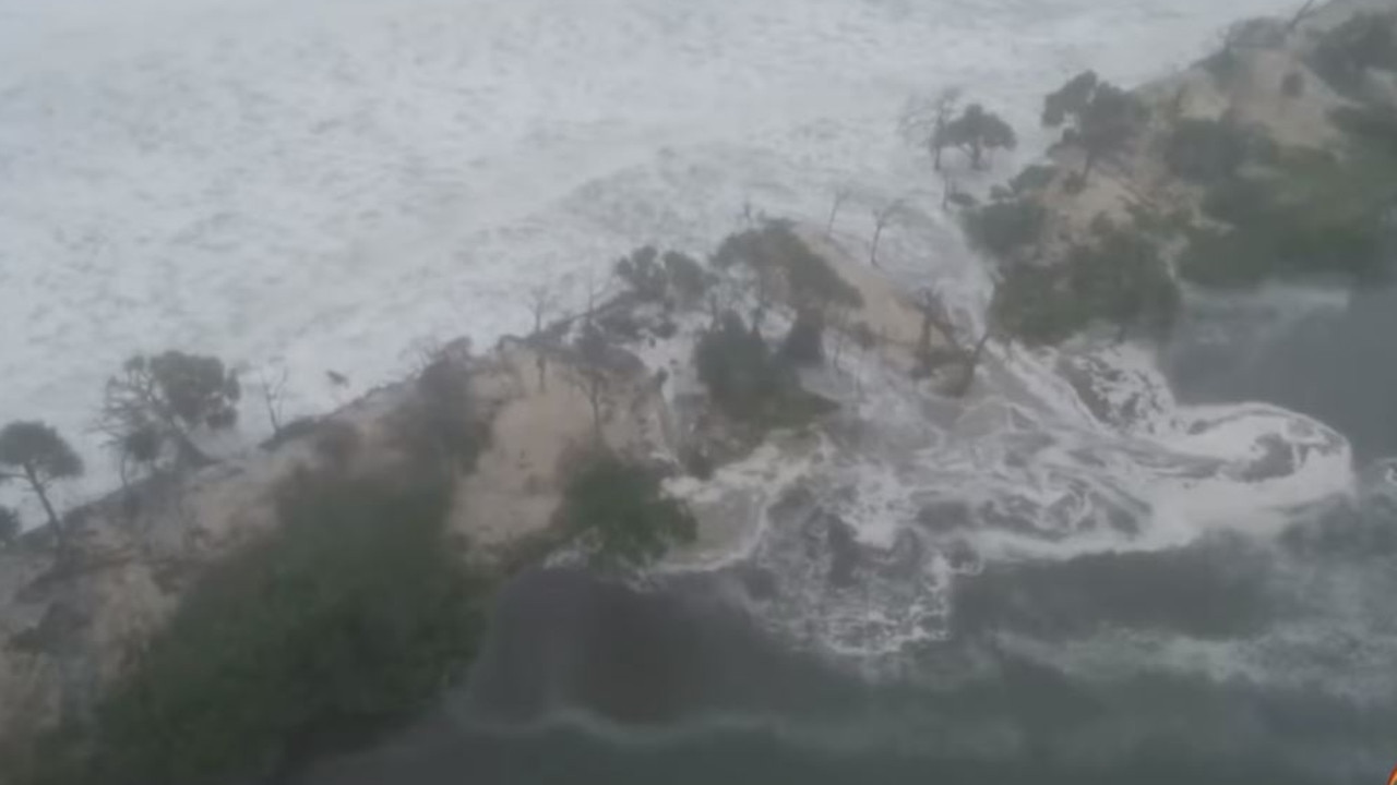 Waves crash through Bribie Island dunes. Picture: Sunrise/Channel 7