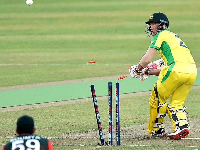 Australia's wicketkeeper Josh Philippe is clean bowled by Bangladesh's Mustafizur Rahman (not pictured) during the second Twenty20 international cricket match between Bangladesh and Australia at the Sher-e-Bangla National Cricket Stadium in Dhaka on August 4, 2021. (Photo by Munir Uz zaman / AFP)