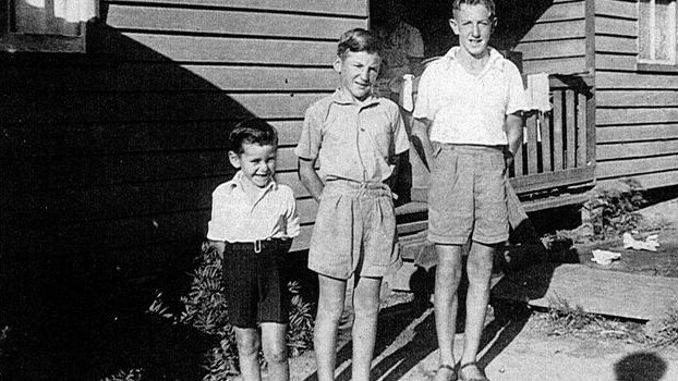 Mike Ryan (left) with his brothers outside the Ryan house on the west side of the Nambucca Station gates. A fettler's house was only modest and the Ryan family of 11 filled every inch with the boys following in their father's footsteps as railway workers. Picture: Nambucca Heads Station Rail Centenary 1923 - 2023 Facebook page