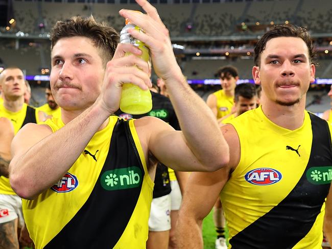 PERTH, AUSTRALIA - JUNE 10: Liam Baker and Daniel Rioli of the Tigers lead the team from the field after winning the round 13 AFL match between Fremantle Dockers and Richmond Tigers at Optus Stadium, on June 10, 2023, in Perth, Australia. (Photo by Paul Kane/Getty Images)