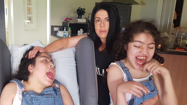 Danielle Phelps claims she's been harassed by the Education Department to move her disabled children Jordyn, 21 (left) and Juliana, 18 (right) to another school. Picture: Kiel Egging.