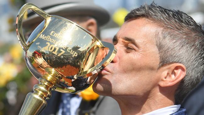 Corey Brown kisses the 2017 Melbourne Cup after winning on Rekindling. Picture: Getty Images