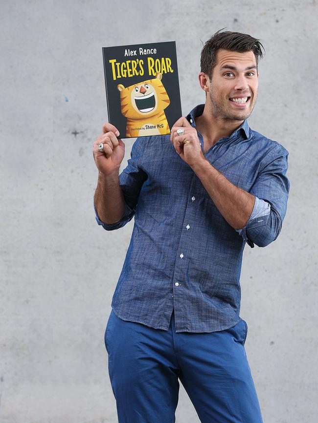 Richmond footballer Alex Rance with his book. Picture: Ian Currie