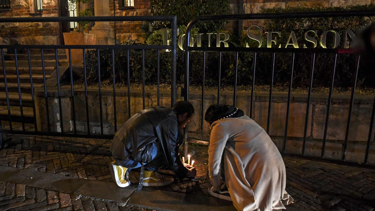 People light candles in front a hotel for late Foo Fighters' drummer Taylor Hawkins. Picture: AFP