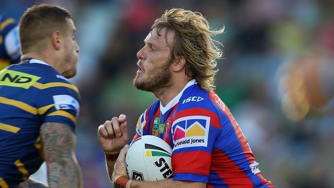 Nathan Ross of the Knights is tackled during a trial against the Eels.