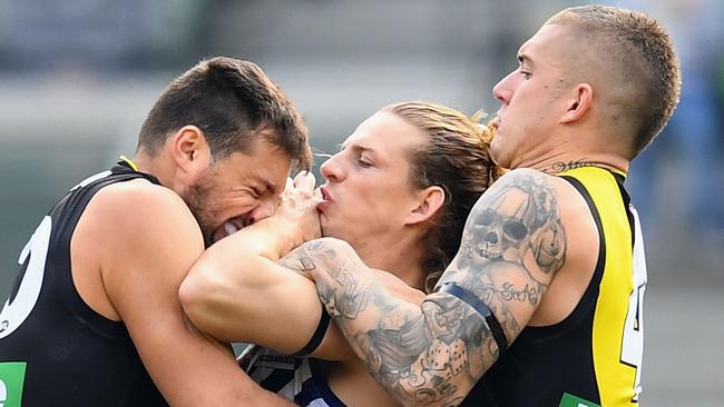 Nat Fyfe is tackled by Toby Nankervis and Dustin Martin. Picture: Getty Images