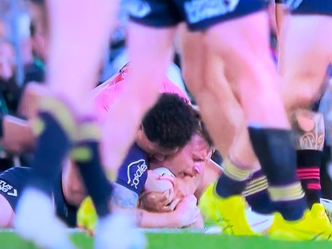 Alamoti appeared to wrap his arm across Munster’s mouth. Picture: Channel 9