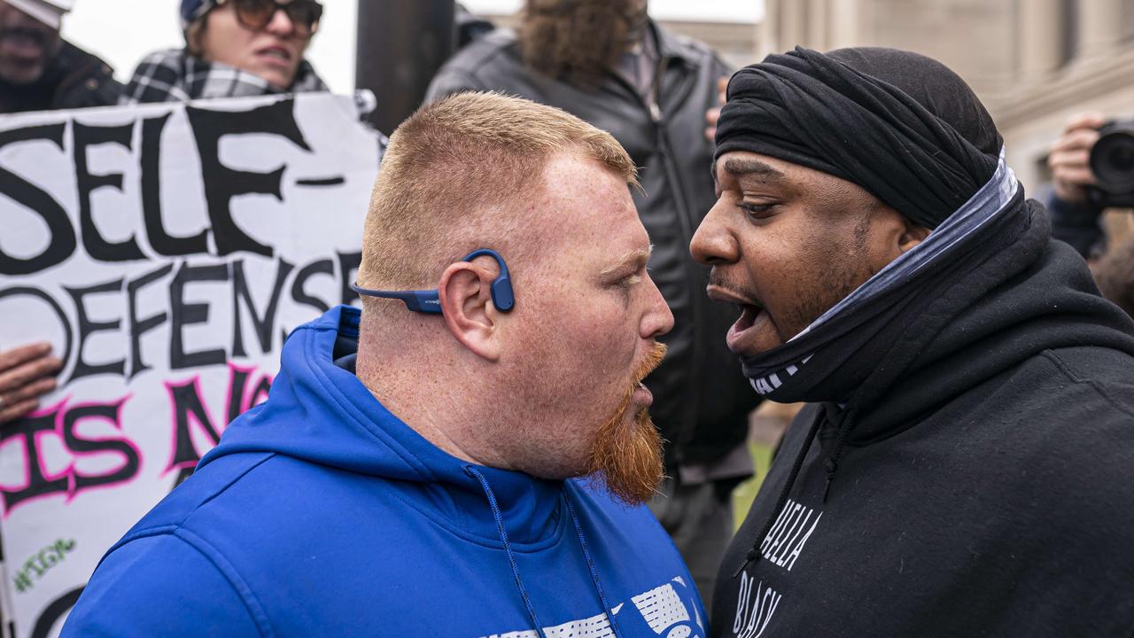 A supporter of Kyle Rittenhouse (L) argues with a Black Lives Matter supporter in front of the Kenosha County Courthouse. Picture: Nathan Howard/Getty Images/AFP