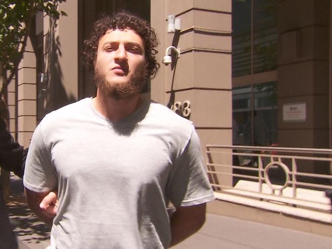 One of the men arrested in Melbourne terror raids, Ahmed Mohamed, leaves AFP HQ. Picture: Nine News