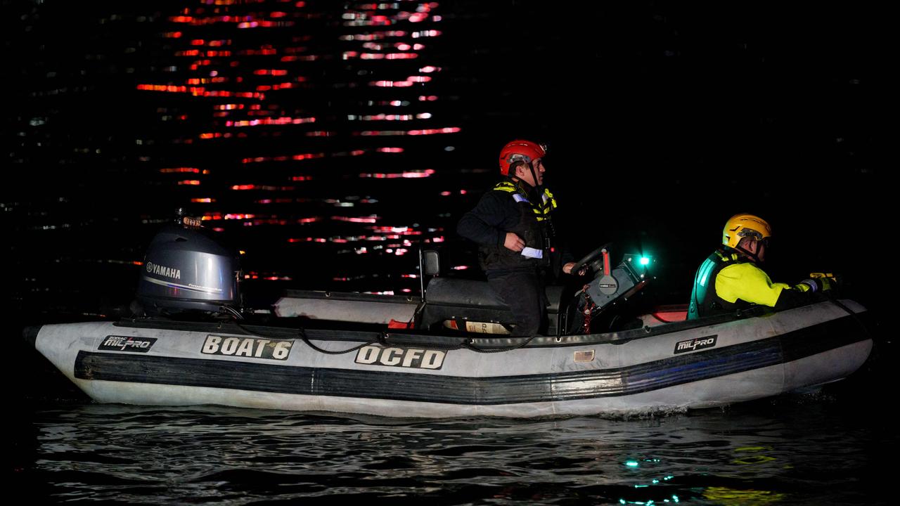 An emergency response team with Washington, DC Fire and EMS make their way to airplane wreckage in the Potomac River near Ronald Reagan Washington Airport.