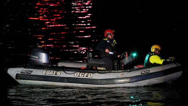 An emergency response team with Washington, DC Fire and EMS make their way to airplane wreckage in the Potomac River near Ronald Reagan Washington Airport.