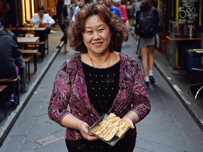 Shandong Mama founder Meiyan Wang and a plate of her famous pan-fried dumplings. Picture: Jake Nowakowski