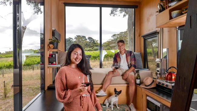 Jasmine Belford and Kevin Mendoza of Marion and their dog Korra, enjoying a staycation at CABN in Kuitpo, one of the unique places available for people lucky enough to score a travel voucher. Picture: Brenton Edwards