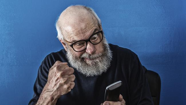 Old man angry at phone. Stock image from istock