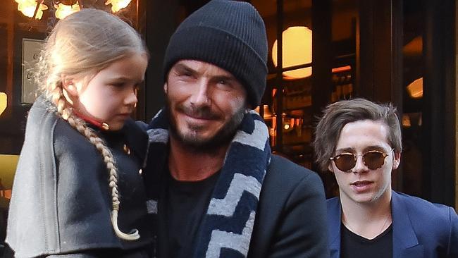 David Beckham carries daughter Harper as they leave Balthazar in SoHo