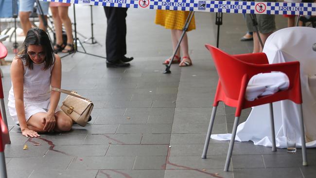 Vivian Vo, aged 49, breaks down in tears outside the Happy Cup cafe in Bankstown where lawyer, Ho Ledinh, was murdered. Picture: John Grainger