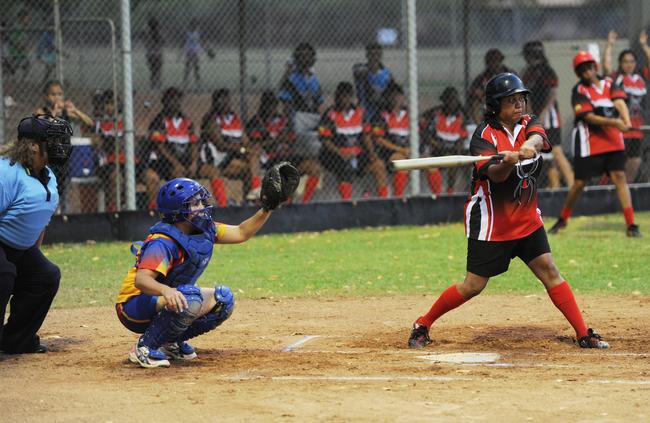 Redbacks' Carmel Croydon swings while Tracy Village catcher Teri Cubillo waits at the NT Softball championships.