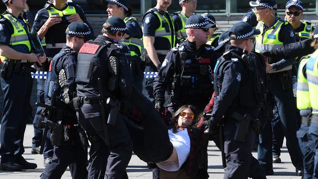 A climate change protester is removed by police during a demonstration on Princes Bridge, Melbourne, last month. Picture: AAP