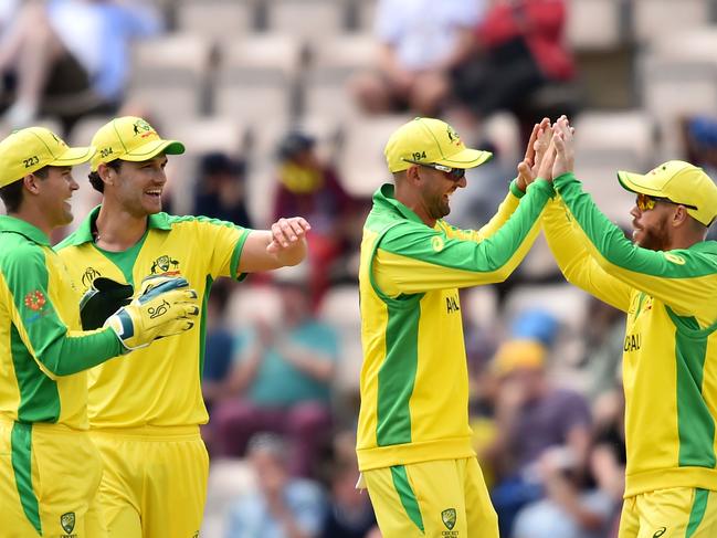 United front: Australia's David Warner (right) celebrates with teammates after taking a catch to dismiss England's Jonny Bairstow in their World Cup warm up match against England.