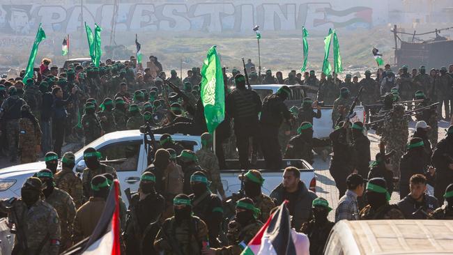 Hamas fighters gather in Gaza City on Saturday for the release of Israeli hostage Keith Siegel. Photo: AFP