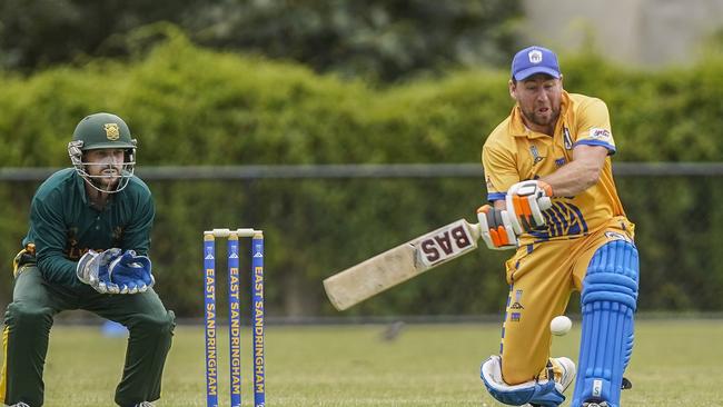 Elwood keeper Stewart Clark watches on as East Sandringham batsman Mark Devereaux goes the sweep. Picture: Valeriu Campan