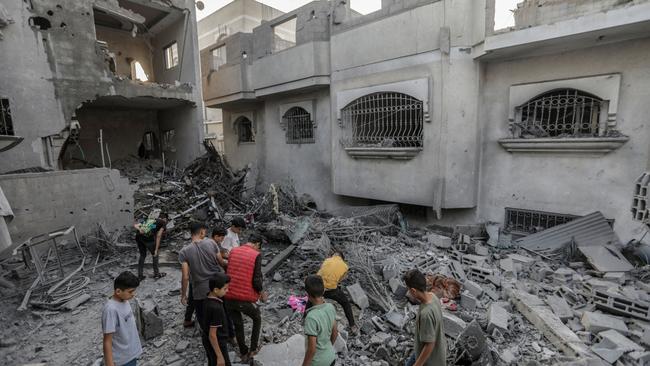 People search through buildings destroyed in Khan Yunis, Gaza, during Israeli air strikes in the southern Gaza Strip.  Picture: Ahmad Hasaballah/Getty Images