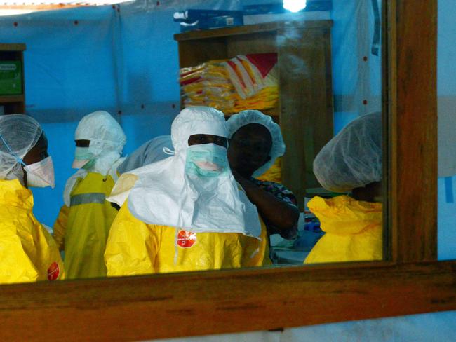 Precautions ... health workers don protective outfits before entering a high-risk area of Elwa hospital in Monrovia. Picture: AFP