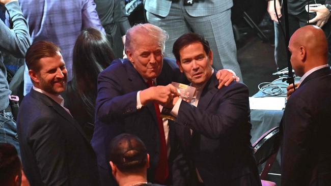 US President Donald Trump (C), Eric Trump and US Secretary of State Marco Rubio (R) UFC 316. (Photo by ANDREW CABALLERO-REYNOLDS / AFP)