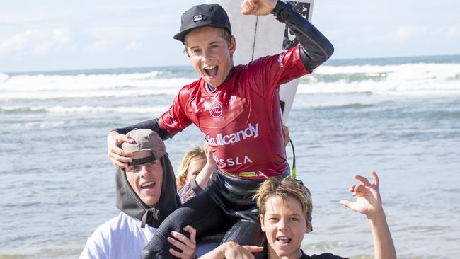 Max McGillivray of Evans Head is chaired from the water after winning the 14s boys title at the 2022 Oz Grom Open at Lennox Head on July 11.