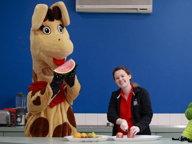 Emily Leonarder educator helping Healthy Harold the Giraffe from Life Education preparing some healthy snacks. Picture: Carmela Roche