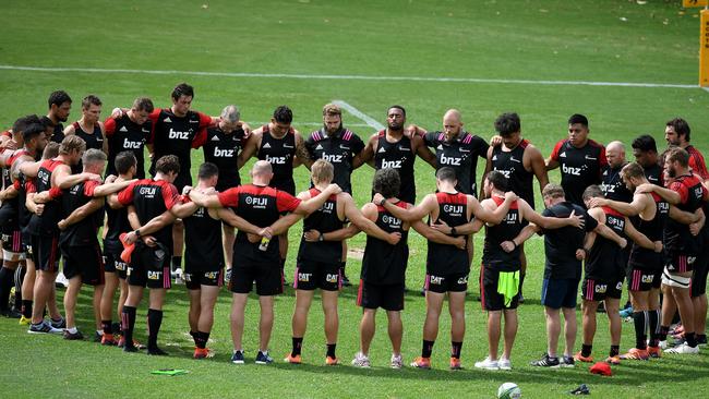 Canterbury Crusaders players and staff pause during their Captain's Run training session for two minute's silence, a week on from the Christchurch terror attack, at 11.32am Sydney time, at The Scots College, in Sydney. Picture: AAP 