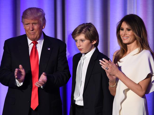 US President-elect Donald Trump arrives with his son Baron and wife Melania at the New York Hilton Midtown in New York on November 8, 2016. Trump stunned America and the world Wednesday, riding a wave of populist resentment to defeat Hillary Clinton in the race to become the 45th president of the United States. / AFP PHOTO / SAUL LOEB