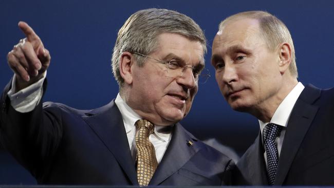 IOC president Thomas Bach, left, with Putin at the 2014 Games. Picture: AP