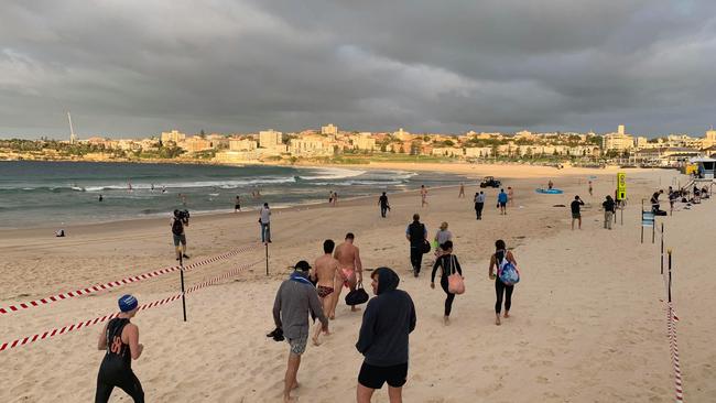 Bondi locals return to the beach as it reopens.